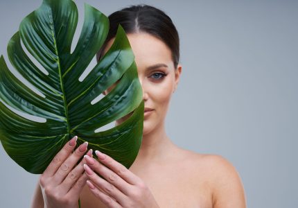 Portrait of beautiful woman over gray background